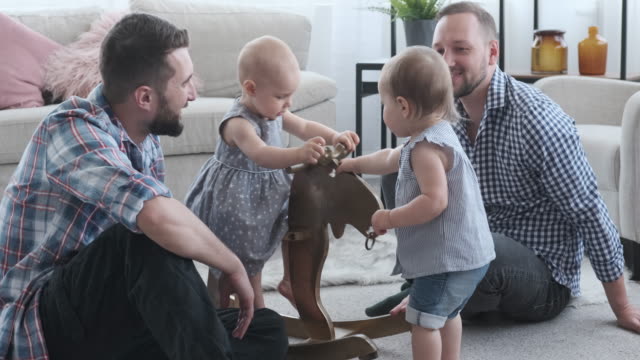 Fathers-and-baby-girls-playing-with-rocking-deer
