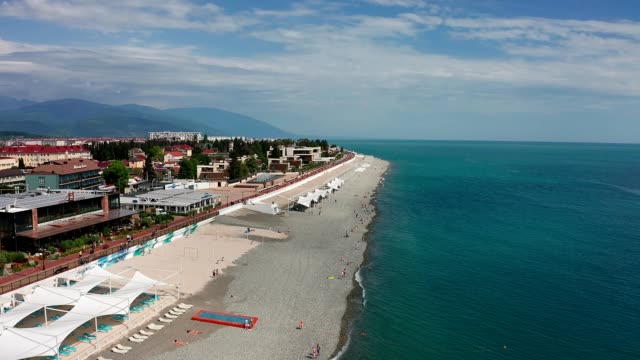 Aerial-video-shooting.-The-black-sea-coast-of-Sochi,-Russia.-Mountain-view.-A-place-of-rest-and-entertainment.-Hotels-and-houses-on-the-coast.-Infrastructure-for-recreation-and-entertainment.