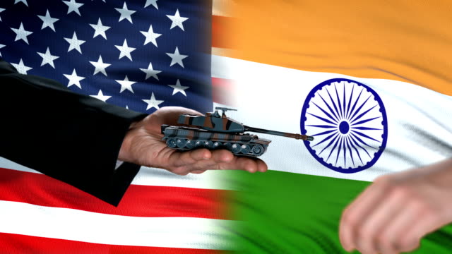 USA-and-India-officials-exchanging-tank-for-money,-weapon-trade,-flag-background