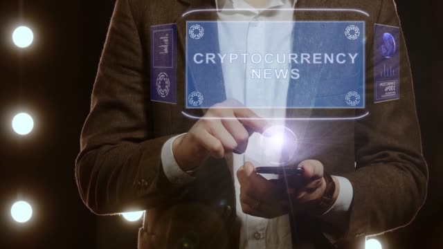 Businessman-shows-hologram-with-text-Cryptocurrency-news