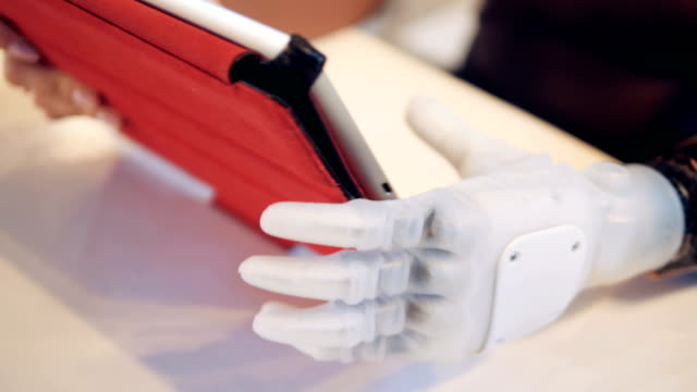 Artificial-arm-is-holding-a-tablet-computer