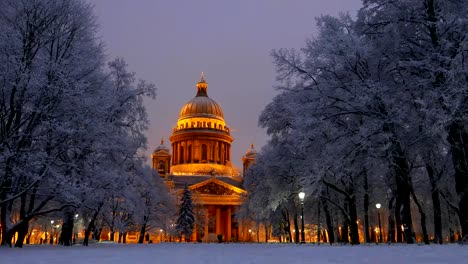 Saint-Isaac's-Cathedral-seen-between-trees-under-snow,-winter-time,-night-shot