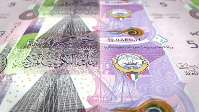 Banknotes-of-five-kuwaiti-dinar-of-the-bank-of-Kuwait-rolling-on-screen,-coins-of-the-world,-cash-money,-loop