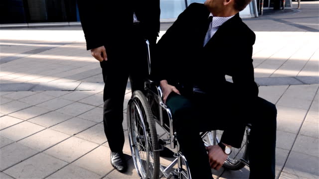 Happy-disabled-businessman,-spending-time-in-business-district-with-his-friend