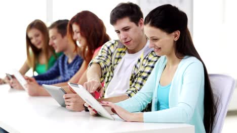 happy-students-with-tablet-pc-computers-learning-at-school