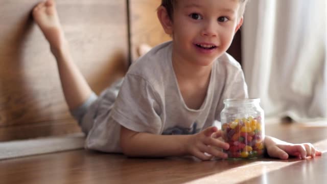 boy-playing-with-jar-of-candies
