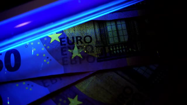 Fälschung-von-Geld-zu-erkennen.-Cheking-Euro-Banknoten-mit-UV-Licht.