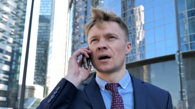 Walking-Businessman-in-Suit-Talking-on-Phone