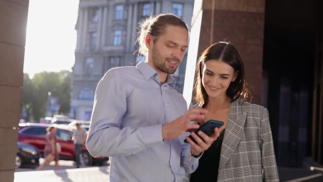 People,-Technology.-Business-Man-And-Woman-Using-Phone-Outdoors