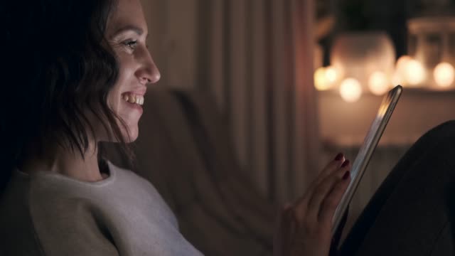 Woman-using-digital-tablet-at-night
