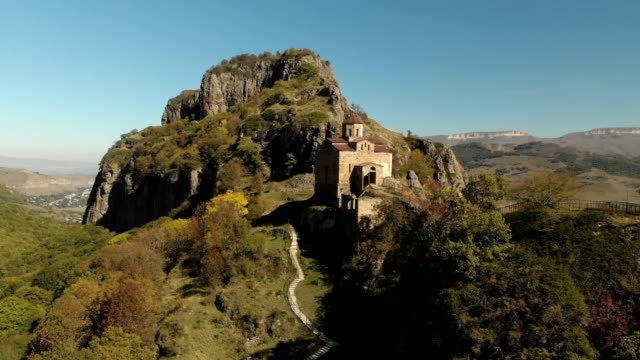 4K-UHD-Aerial-view-of-a-mountain-monastery-standing-on-a-cliff