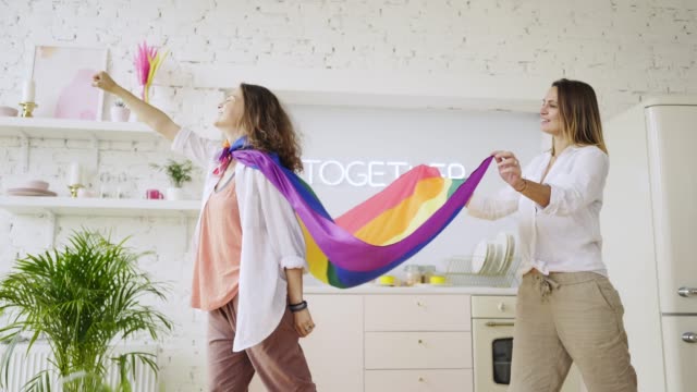 Girlfriends-have-fun-with-rainbow-flag