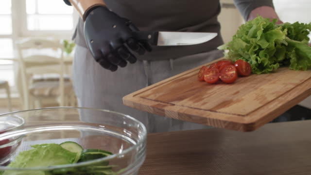 Self-Sufficient-Amputee-with-Prosthetic-Forearm-Making-Salad