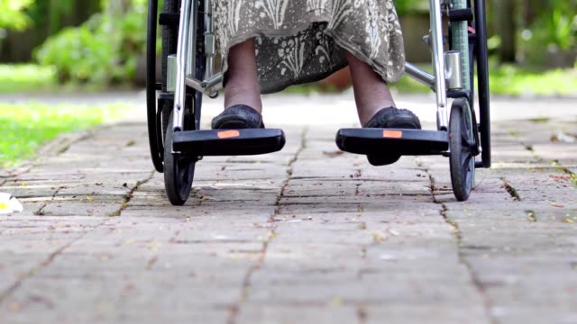 Daughter-take-care-elderly-mother-on-wheelchair-at-home