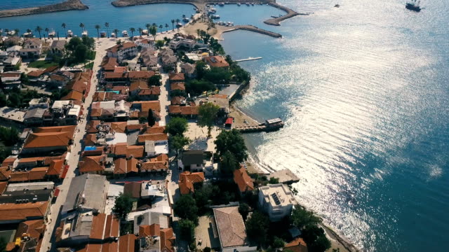Old-city-with-terra-cotta-tile-rooftops-drone-aerial-view.-Small-coast-city-near-the-sea-with-marina