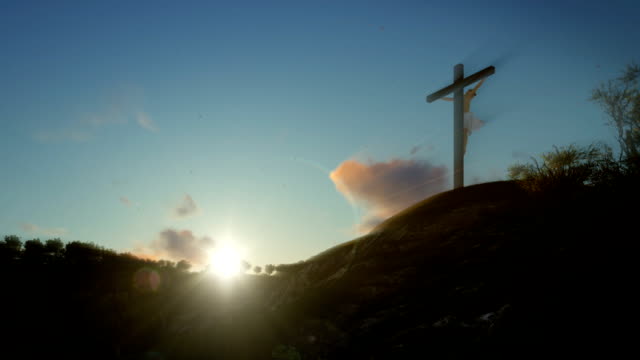 Christian-woman-praying-at-Jesus-cross-at-sunrise,-zoom-out
