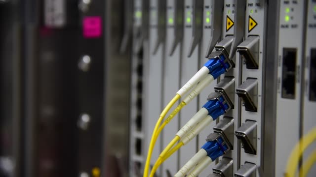 Networking-Temecommunication-fiber-optics-cable-patch-cord-connected-and-blinking-of-led-status-in-data-center