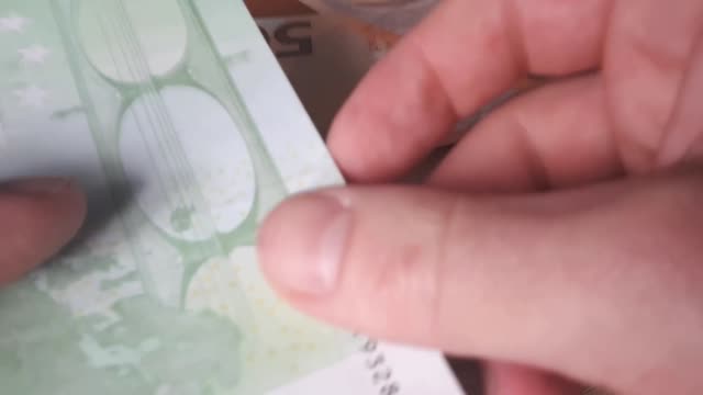 Man-Counting-100-Euro-Banknotes