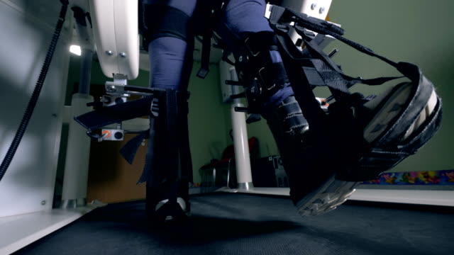 Close-up-of-fixated-legs-walking-along-the-simulation-machine
