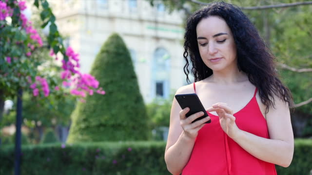 European-Young-Girl-or-Woman-Cute-Cheerful-Girl-Brunette-typing-texting-on-the-smartphone,-woman-talking-on-phone.-Young-woman-calling-via-mobile-phone.-Young-woman-checking-mail-by-mobile-phone.