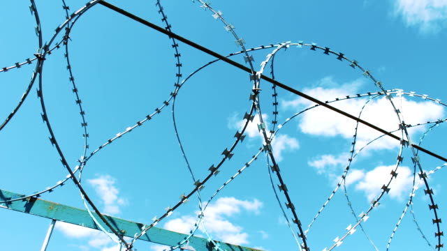 Barbed-wire-fence.-Place-of-deprivation-of-liberty.-Prison-territory.-Protection-against-escape.-Crime,-fraud.-jail-break.-Fencing-with-barbed-wire