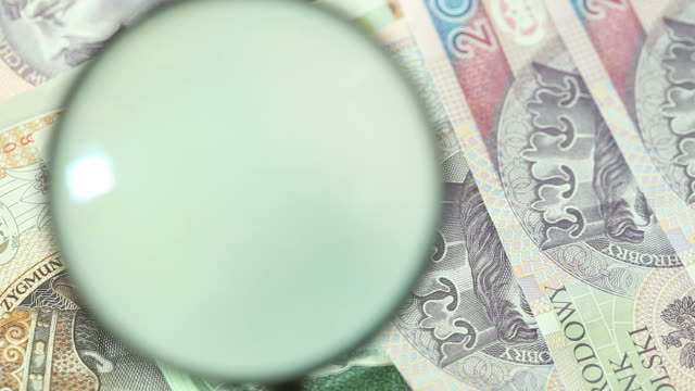 Banknotes-with-magnifying-glass