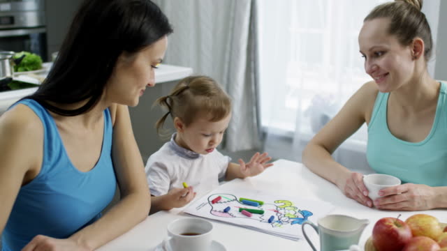 Toddler-with-Two-Mothers-Coloring-in-Kitchen