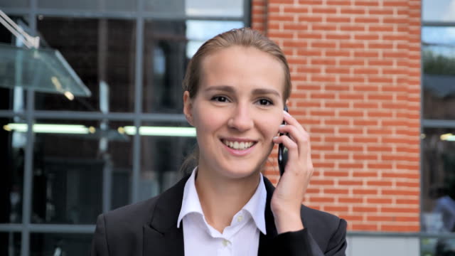 Walking-Businesswoman-Talking-on-Phone