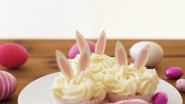cupcakes-with-easter-eggs-and-candies-on-table