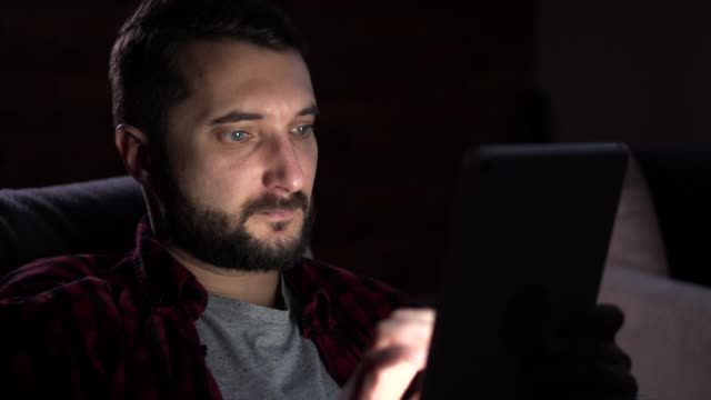 Hombre-usando-tableta-digital-en-la-noche