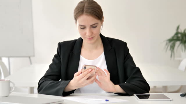 Young-Businesswoman-Using-Smartphone
