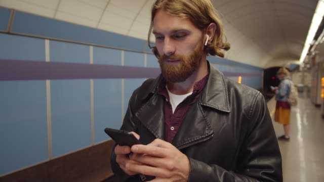 Ginger-Man-Using-Smartphone-at-Subway-Station