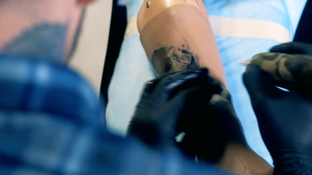 Black-image-is-getting-tattooed-on-an-artificial-arm