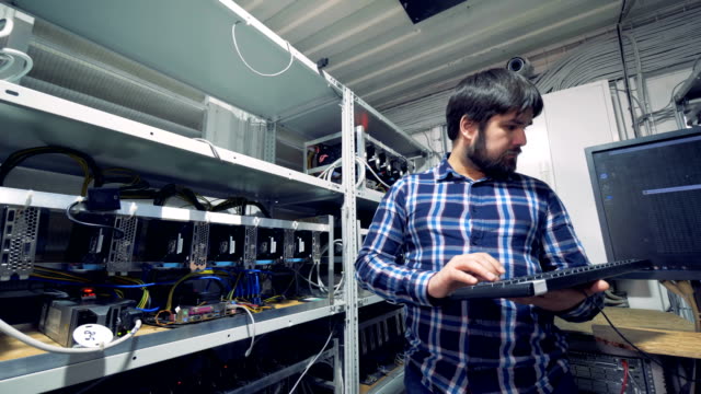Man-works-with-computers,-mining-cryptocurrencies.