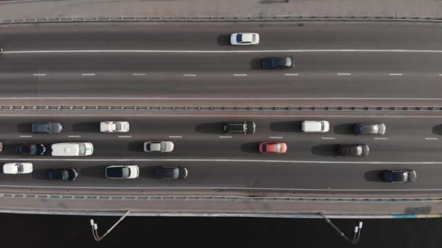 Highway-traffic-on-bridge-aerial-top-view-ascending-shot