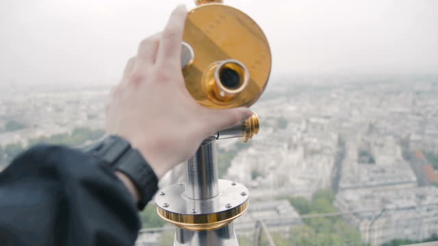 Sightseeing-telescope-on-Eiffel-Tower,-Paris,-France.-View-of-Paris-from-the-upper-balcony-in-the-spring-March-day