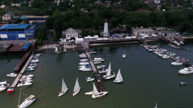 Aerial-view-on-sail-boats-float-on-the-sea.-Calm-sea-and-sail-boats-by-the-pier.-Yachts-and-boats