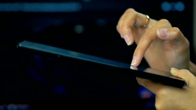 SLOW-MOTION:-a-female-hand-writing-a-message-on-a-tablet-on-a-laptop-screen-background.