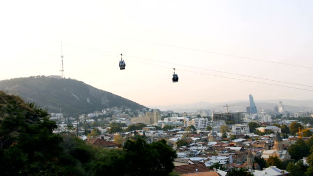 City-of-Tbilisi-gets-lively-and-busy-in-the-morning,-Georgia,-cabins-coming-up-by-ropeway