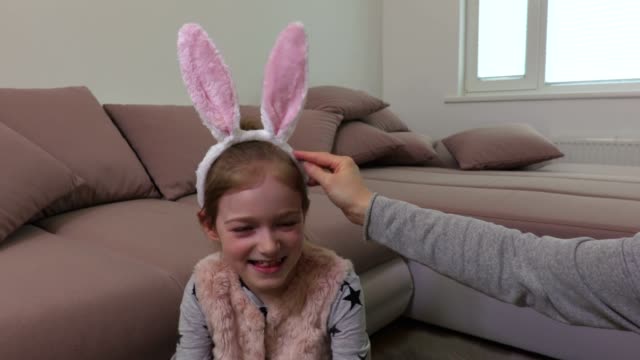Smiling-little-girl-trying-white-bunny-ears