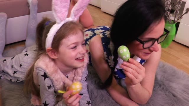 Mother-and-daughter-with-Easter-eggs-on-the-floor