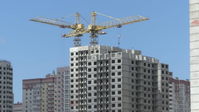 A-lake-against-the-background-of-houses-under-construction.-Skyscrapers-are-built-near-the-lake.-Construction-of-residential-buildings-near-the-lake.