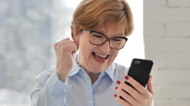 Old-Woman-Excited-for-Success-while-Using-Smartphone