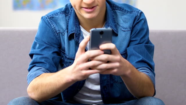 Angry-high-schooler-playing-video-game-losing-on-smartphone,-anger-management