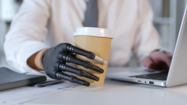 Unrecognizable-Businessman-with-Robotic-Prosthetic-Arm-Working