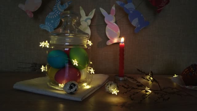 Easter-decoration-burning-candles-eggs-garlands
