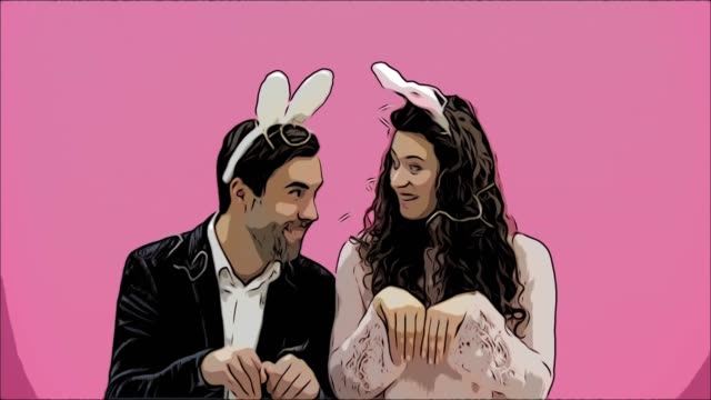 Young-sexy-couple-on-pink-background.-With-hackneyed-ears-on-the-head.-During-this-reproduction-sexual-rabbit-movements-and-looks,-after-a-while-go-out-of-the-frame.-The-concept-of-a-shrill.