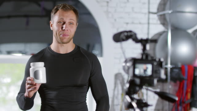 Sportsman-Telling-about-Supplements-on-Camera-while-Recording-Vlog