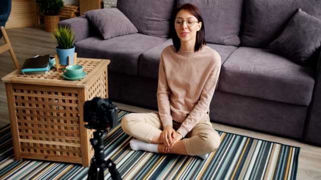 Female-blogger-recording-video-at-home-talking-and-gesturing-using-camera