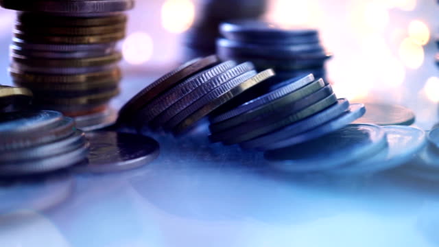 Double-exposure-of-city-view-and-rows-of-coins-for-finance-,-money-,-investment-and-business-concept-background